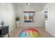 Minimalist office space featuring a unique rug and a bright window view at 4960 E Colonial Dr, Chandler, AZ 85249