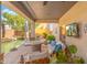 Inviting covered patio with comfortable seating, an outdoor TV, and a serene pool view at 4960 E Colonial Dr, Chandler, AZ 85249