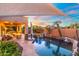 Tranquil backyard oasis with pool, waterfall, covered patio, and lush tropical landscaping at 4960 E Colonial Dr, Chandler, AZ 85249