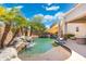 Stunning backyard pool featuring a rock waterfall and ample space for entertaining and relaxing outdoors at 4960 E Colonial Dr, Chandler, AZ 85249