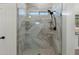 Shower featuring marble tiling, a glass door, and built in shelving at 4960 E Colonial Dr, Chandler, AZ 85249