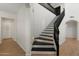 Staircase with black railings, leading to the upper level of the home at 4960 E Colonial Dr, Chandler, AZ 85249