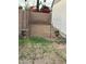 Backyard with grass and a rock wall, metal garden arch, and pots at 5143 W Mountain View Rd, Glendale, AZ 85302