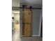 Rustic wood barn door adding charm and character to the home's interior at 5143 W Mountain View Rd, Glendale, AZ 85302