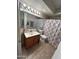 Bathroom with a mirror and vanity with a shower and toilet at 5143 W Mountain View Rd, Glendale, AZ 85302