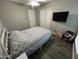 Bedroom with dark wood laminate flooring, white trim, and neutral colored walls at 5143 W Mountain View Rd, Glendale, AZ 85302
