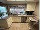 Well-lit kitchen with granite countertops, stainless steel appliances, and backyard view at 5143 W Mountain View Rd, Glendale, AZ 85302