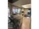 Bright kitchen with a breakfast bar, a double sink, and a view of the outdoor patio at 5143 W Mountain View Rd, Glendale, AZ 85302