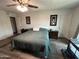 Calm main bedroom with a ceiling fan, wood-look flooring, and natural light at 5143 W Mountain View Rd, Glendale, AZ 85302