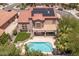 Aerial view of a home with a private pool, patio, and solar panels on the roof at 5212 S Monte Vista St, Chandler, AZ 85249