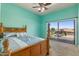Bedroom with light-blue walls, wooden headboard, ceiling fan, and access to the outdoor balcony at 5212 S Monte Vista St, Chandler, AZ 85249