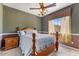Comfortable bedroom with a queen-sized bed, natural light, and wood accents at 5212 S Monte Vista St, Chandler, AZ 85249