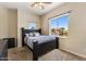 Inviting bedroom with large window offering neighborhood views, ceiling fan, and plush carpeting at 5212 S Monte Vista St, Chandler, AZ 85249