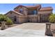 Elegant two-story home featuring a tile roof, three-car garage, and lush front yard landscaping at 5212 S Monte Vista St, Chandler, AZ 85249