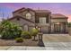 Stunning two-story home showcasing mature landscaping, a tile roof, and an iron gated entry at 5212 S Monte Vista St, Chandler, AZ 85249