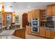 Well-equipped kitchen with granite counters, light wood cabinets, and stainless steel appliances at 5212 S Monte Vista St, Chandler, AZ 85249