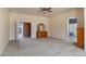 Expansive living room with plush carpeting, neutral walls, and views into the bathroom area at 5212 S Monte Vista St, Chandler, AZ 85249