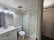 Bathroom features a shower with sliding glass door, toilet, and sink at 5446 W Sheena Dr, Glendale, AZ 85306