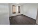 A bedroom featuring neutral colored carpet, a window with blinds and plain walls at 5446 W Sheena Dr, Glendale, AZ 85306