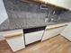Kitchen with granite countertops, stainless steel sink, and white cabinets at 5446 W Sheena Dr, Glendale, AZ 85306