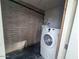 The laundry room includes a washing machine and brick walls in the utility area at 5446 W Sheena Dr, Glendale, AZ 85306