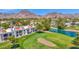 Scenic aerial view of the property showcasing the golf course, lake, desert landscape, and mountain views at 6131 N 28Th Pl, Phoenix, AZ 85016