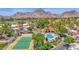 Beautiful aerial view of the tennis courts, pool, desert landscape, and mountains making this community a desert oasis at 6131 N 28Th Pl, Phoenix, AZ 85016