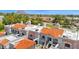 Stunning aerial view of the condo complex with orange tile roofs, beautiful desert landscaping and mountain backdrop at 6131 N 28Th Pl, Phoenix, AZ 85016
