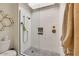 Bathroom shower featuring white tiles, glass door, and upgraded bronze fixtures at 6131 N 28Th Pl, Phoenix, AZ 85016
