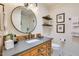 Elegant bathroom featuring a modern vanity, round mirror, and glass-enclosed shower at 6131 N 28Th Pl, Phoenix, AZ 85016