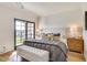 Comfortable bedroom with plush bedding, stylish decor, and balcony access at 6131 N 28Th Pl, Phoenix, AZ 85016