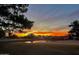 Scenic view of a golf course and pond reflecting the vibrant sunset, enhancing the community's appeal at 6131 N 28Th Pl, Phoenix, AZ 85016