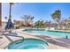 Community hot tub and pool area with lounge chairs and manicured landscaping at 6131 N 28Th Pl, Phoenix, AZ 85016