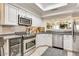 Well-equipped kitchen with stainless steel appliances and white cabinetry at 6131 N 28Th Pl, Phoenix, AZ 85016