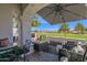 Charming covered patio with elegant seating, a fireplace, and picturesque views of the golf course at 6131 N 28Th Pl, Phoenix, AZ 85016