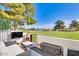 Relaxing outdoor patio with comfortable seating, fireplace, and scenic golf course views at 6131 N 28Th Pl, Phoenix, AZ 85016