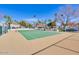 Well-maintained tennis court surrounded by lush landscaping and trees at 6131 N 28Th Pl, Phoenix, AZ 85016