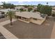 Aerial view of a one-story home with desert landscaping and palm tree at 6217 E Dodge St, Mesa, AZ 85205