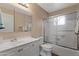 Well-lit bathroom featuring a shower with glass doors and a white vanity at 6217 E Dodge St, Mesa, AZ 85205
