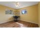 Bedroom featuring laminate floors, natural light, and a desk at 6217 E Dodge St, Mesa, AZ 85205