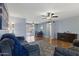 Spacious living area with laminate floors, a ceiling fan, and an adjacent dining space at 6217 E Dodge St, Mesa, AZ 85205