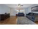 Comfortable living room showcasing natural light, laminate flooring, and cozy furniture at 6217 E Dodge St, Mesa, AZ 85205