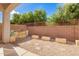 Backyard featuring trees, plants, gravel, and steps leading up to an awning at 6359 S Forest Ave, Gilbert, AZ 85298