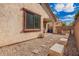 Backyard featuring trees, gravel, pavers, and an awning over a patio at 6359 S Forest Ave, Gilbert, AZ 85298