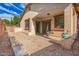Backyard featuring trees, gravel, pavers, and steps leading up to an awning at 6359 S Forest Ave, Gilbert, AZ 85298