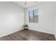 A clean, bright bedroom with hard wood flooring, a window, and modern accents at 6359 S Forest Ave, Gilbert, AZ 85298