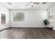 Bright, open bedroom with wood floors, ceiling fan, and door to backyard at 6359 S Forest Ave, Gilbert, AZ 85298