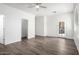 Bright, open bedroom with wood floors, ceiling fan, and doors to backyard at 6359 S Forest Ave, Gilbert, AZ 85298