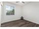 A clean, well-lit bedroom with hard wood flooring, a window, and neutral paint at 6359 S Forest Ave, Gilbert, AZ 85298