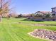 Open community green space with manicured lawn and stone features offering a serene environment at 6359 S Forest Ave, Gilbert, AZ 85298